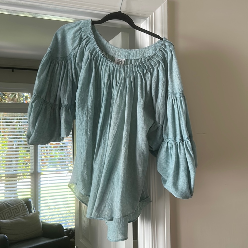 Full light turquoise top. Quarter length sleeves